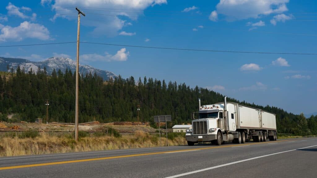 A Class 8 semi truck travelling a highway through the mountains in British Columbia, Canada